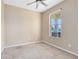 Simple bedroom with large window and ceiling fan at 1407 Retreat Cir, Clermont, FL 34714