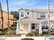 Two-story home with a front porch and landscaping at 1407 Retreat Cir, Clermont, FL 34714