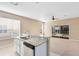 Kitchen with breakfast bar overlooking the Gathering room at 1407 Retreat Cir, Clermont, FL 34714