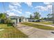 Landscaped yard with a one story house and basketball hoop at 1424 Sheridan Sw St, Winter Haven, FL 33880