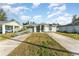 One-story home with a green exterior, driveway, and basketball hoop at 1424 Sheridan Sw St, Winter Haven, FL 33880