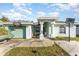 House with green exterior, driveway, and basketball hoop at 1424 Sheridan Sw St, Winter Haven, FL 33880