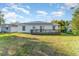 House back view with deck and solar panels at 1424 Sheridan Sw St, Winter Haven, FL 33880