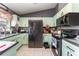 Modern kitchen featuring stainless steel appliances and light green cabinetry at 1424 Sheridan Sw St, Winter Haven, FL 33880