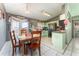 Kitchen with light green cabinets and a dining table at 1424 Sheridan Sw St, Winter Haven, FL 33880