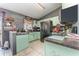 Bright kitchen with light green cabinets and black appliances at 1424 Sheridan Sw St, Winter Haven, FL 33880