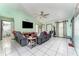 Living room with gray couches, TV, and tile floors at 1424 Sheridan Sw St, Winter Haven, FL 33880