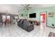 Open concept living and dining area with gray couches and dining table at 1424 Sheridan Sw St, Winter Haven, FL 33880