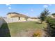 House backyard with grassy lawn and patio at 1504 Oak Marsh Loop, Davenport, FL 33837