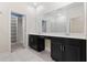 Modern bathroom with double vanity and large mirror at 1504 Oak Marsh Loop, Davenport, FL 33837