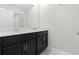 Clean bathroom with dark vanity and double sinks at 1504 Oak Marsh Loop, Davenport, FL 33837