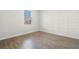 Bright bedroom featuring wood-look floors and white wainscoting at 1504 Oak Marsh Loop, Davenport, FL 33837