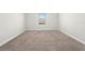 Bright bedroom with carpeted floor and window at 1504 Oak Marsh Loop, Davenport, FL 33837