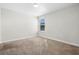 Spacious bedroom featuring carpeted floors and a window at 1504 Oak Marsh Loop, Davenport, FL 33837