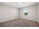 Bright bedroom with carpeted floor and a window at 1504 Oak Marsh Loop, Davenport, FL 33837