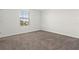 Simple bedroom with carpeted floor and window at 1504 Oak Marsh Loop, Davenport, FL 33837