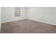 Well-lit bedroom with carpeted floor and window at 1504 Oak Marsh Loop, Davenport, FL 33837