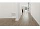 Bright hallway with wood-look tile floors leading to other rooms at 1504 Oak Marsh Loop, Davenport, FL 33837