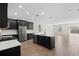 Modern kitchen with dark cabinetry, white countertops, and an island at 1504 Oak Marsh Loop, Davenport, FL 33837