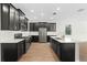 Modern kitchen with dark cabinetry, white countertops, and an island at 1504 Oak Marsh Loop, Davenport, FL 33837