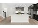 Modern kitchen with island, stainless steel appliances, and dark cabinetry at 1504 Oak Marsh Loop, Davenport, FL 33837