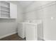 Laundry room with washer, dryer, shelving, and cabinet at 1504 Oak Marsh Loop, Davenport, FL 33837