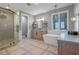 Elegant bathroom with a soaking tub, walk-in shower, and modern vanity at 15863 Burch Island Ct, Winter Garden, FL 34787