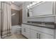 Modern bathroom boasts double vanity, herringbone tile, and a relaxing tub at 15863 Burch Island Ct, Winter Garden, FL 34787