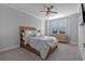 Bright bedroom with wood platform bed, large window, and ample closet space at 15863 Burch Island Ct, Winter Garden, FL 34787