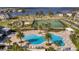 Community pool with lounge chairs and palm trees near lake at 15863 Burch Island Ct, Winter Garden, FL 34787