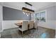 Elegant dining room with rustic wood table and chandelier at 15863 Burch Island Ct, Winter Garden, FL 34787