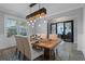 Elegant dining room features a rustic wood table, chandelier, and seating for six at 15863 Burch Island Ct, Winter Garden, FL 34787