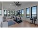 Bright home gym with lake views and various equipment at 15863 Burch Island Ct, Winter Garden, FL 34787