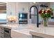 Modern farmhouse kitchen features a large apron sink and black faucet at 15863 Burch Island Ct, Winter Garden, FL 34787