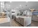 Modern kitchen with large island, white cabinets, and stainless steel appliances at 15863 Burch Island Ct, Winter Garden, FL 34787