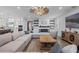 Spacious living room featuring a large sectional sofa, fireplace, and built-in shelving at 15863 Burch Island Ct, Winter Garden, FL 34787