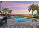 Stunning pool area with a picturesque lake view at sunset at 15863 Burch Island Ct, Winter Garden, FL 34787