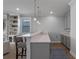 Modern wet bar with quartz countertop and gray cabinetry at 15863 Burch Island Ct, Winter Garden, FL 34787