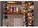 Well-stocked wine cellar with brick walls and metal wine racks at 15863 Burch Island Ct, Winter Garden, FL 34787