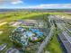 Aerial view showing community pool, playground and surrounding homes at 1611 Kona Ln, Davenport, FL 33897