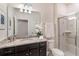 Bathroom with dark brown vanity, granite countertop, and a walk-in shower at 1611 Kona Ln, Davenport, FL 33897