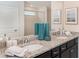 Double vanity bathroom with granite countertops and dark brown cabinets at 1611 Kona Ln, Davenport, FL 33897