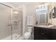 Bathroom with shower, toilet and dark brown vanity with granite countertop at 1611 Kona Ln, Davenport, FL 33897