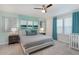 Main bedroom with king-size bed, ensuite bathroom access, and calming decor at 1611 Kona Ln, Davenport, FL 33897