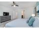 Bedroom with king-size bed, dresser, and access to a shared bathroom at 1611 Kona Ln, Davenport, FL 33897