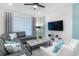 Living room with sectional sofa, coffee table, and a TV mounted above a white brick fireplace at 1611 Kona Ln, Davenport, FL 33897