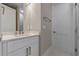 Bright bathroom features a white vanity, chrome fixtures, and a large mirror at 1700 Underwood Ave, St Cloud, FL 34771