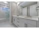 Bathroom with double sink vanity and a glass-enclosed tub and shower at 1700 Underwood Ave, St Cloud, FL 34771