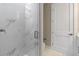 Bathroom featuring a glass shower, marble tile, and a door to the restroom at 1700 Underwood Ave, St Cloud, FL 34771