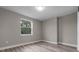 Simple bedroom design featuring a window, neutral walls, and modern wood floors at 1700 Underwood Ave, St Cloud, FL 34771